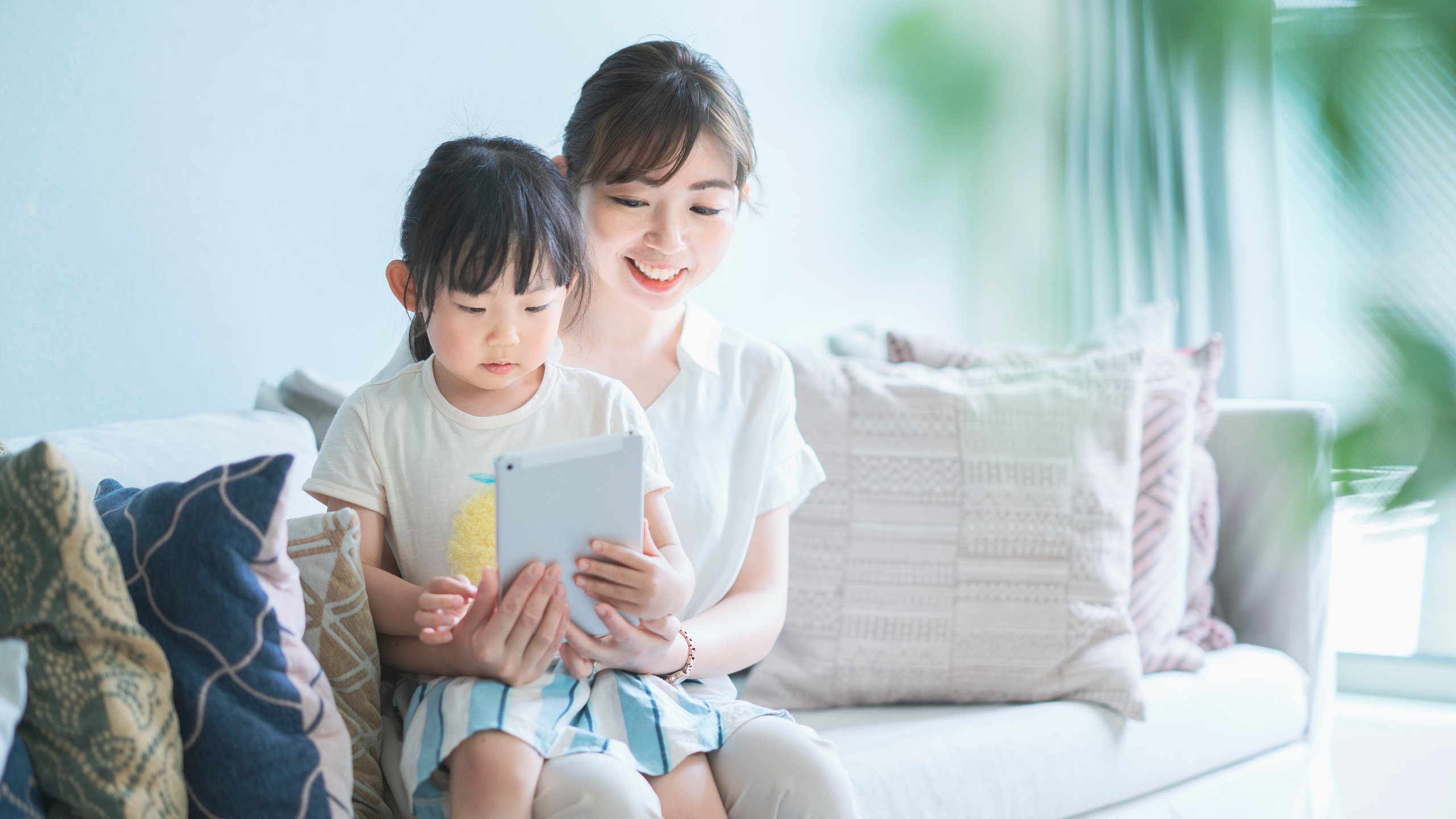 Mom and daughter operating a tablet device